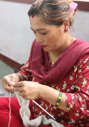 Women hand knitting with wool